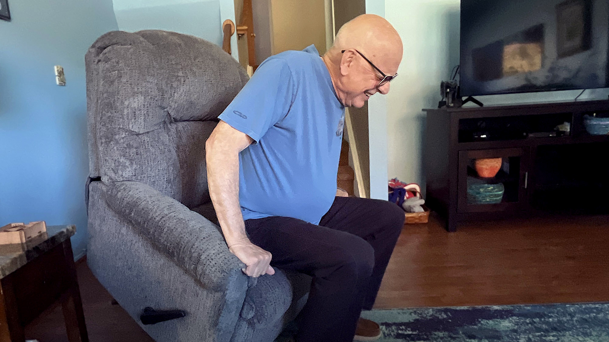 Dad Rocks Back And Forth To Gain Enough Momentum To Sit Up From Chair
